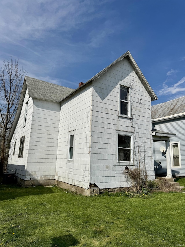 313 E S B St, Gas City, IN 46933 - view of side of property featuring a yard, a shingled roof, and a chimney