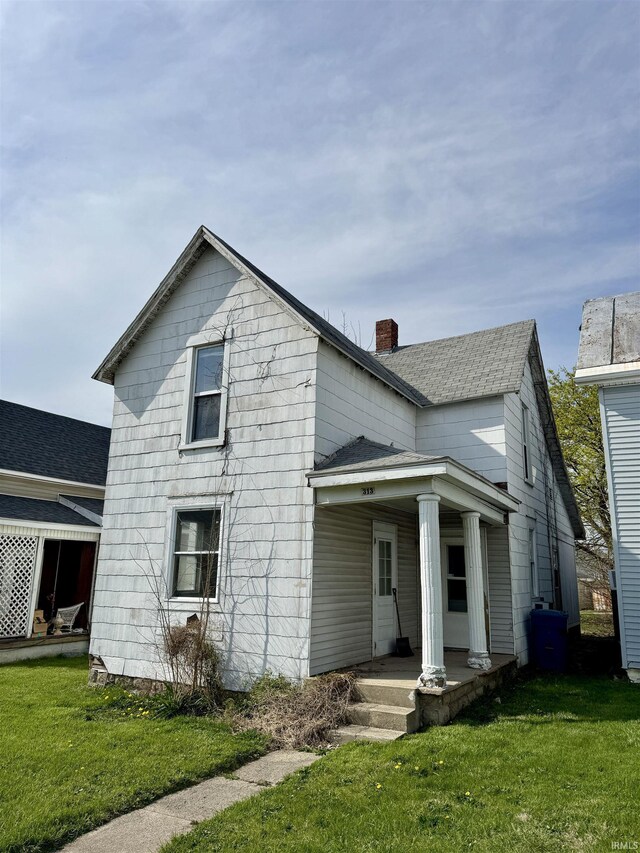 313 E S B St, Gas City, IN 46933 - view of front of property featuring a chimney, a front yard, and covered porch