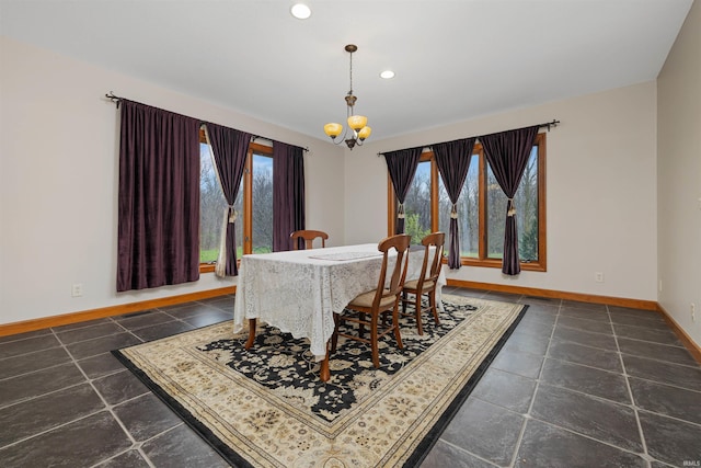 dining area with recessed lighting, baseboards, and a notable chandelier