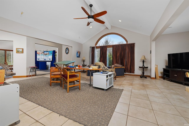 living room featuring a ceiling fan, beam ceiling, high vaulted ceiling, and light tile patterned flooring