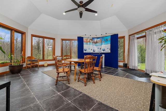 dining space with vaulted ceiling, a healthy amount of sunlight, and a ceiling fan