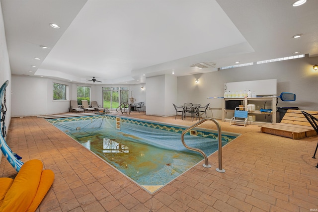 indoor pool featuring a ceiling fan