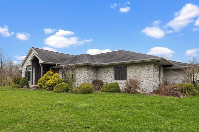 view of side of property featuring a yard, a sunroom, stone siding, and a shingled roof