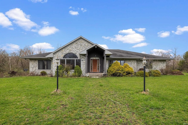 ranch-style house featuring a front lawn and stone siding