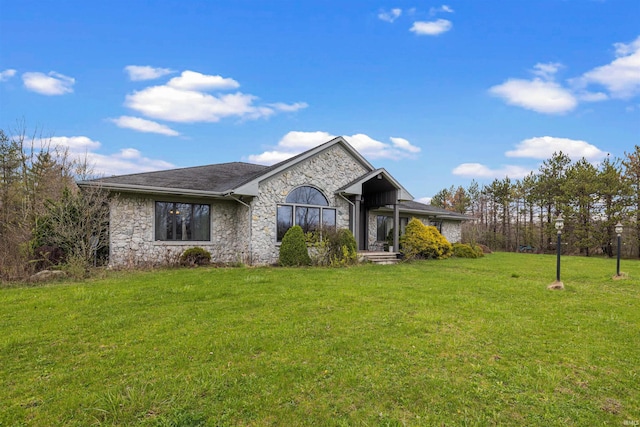 single story home featuring stone siding and a front lawn