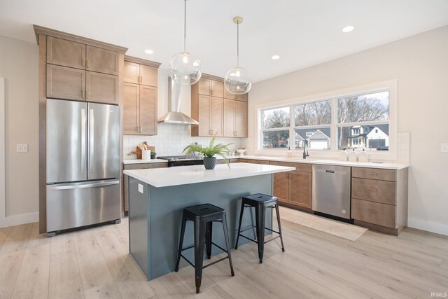 12793 Brick Rd Lot 4, Granger, IN 46530 - kitchen with backsplash, light wood-style floors, appliances with stainless steel finishes, and wall chimney range hood
