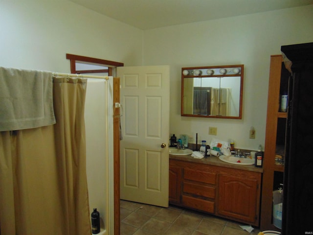 full bath featuring a shower with curtain, tile patterned flooring, a sink, and double vanity