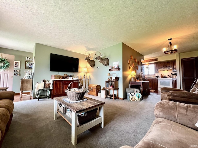 carpeted living room with a textured ceiling and a notable chandelier