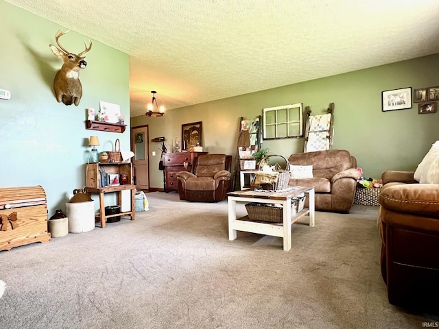 living room featuring a textured ceiling, carpet flooring, and a notable chandelier