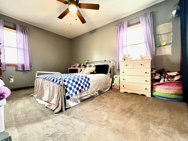 bedroom with carpet floors, a ceiling fan, and multiple windows