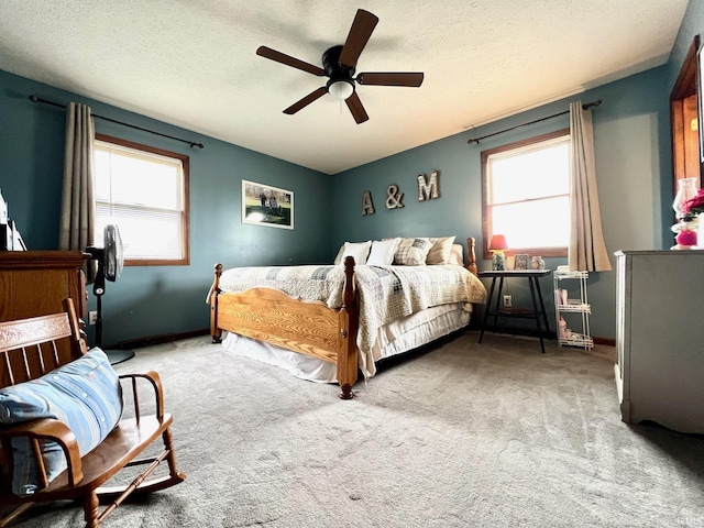 bedroom with carpet, a textured ceiling, baseboards, and ceiling fan