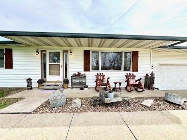 single story home with a porch and a garage