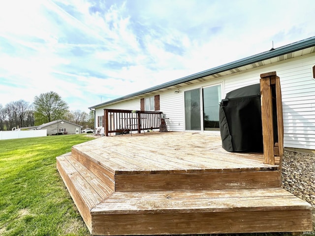 wooden deck with a lawn