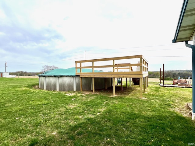 back of property with a yard and a deck