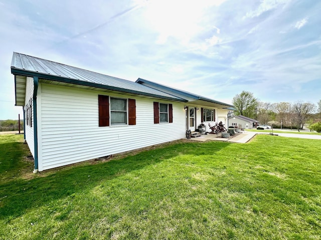 back of property featuring a yard and a patio