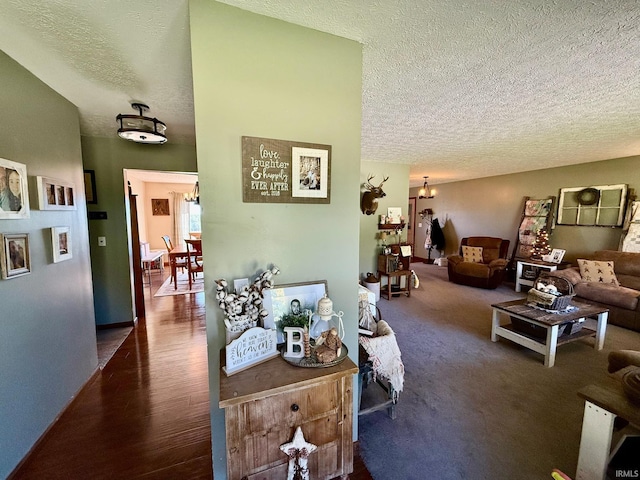living area featuring wood finished floors and a textured ceiling