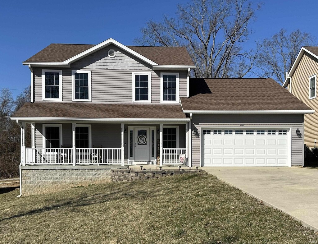 3545 N Hackberry St, Bloomington, IN 47404 - view of front of property with a front lawn, driveway, covered porch, a garage, and a shingled roof