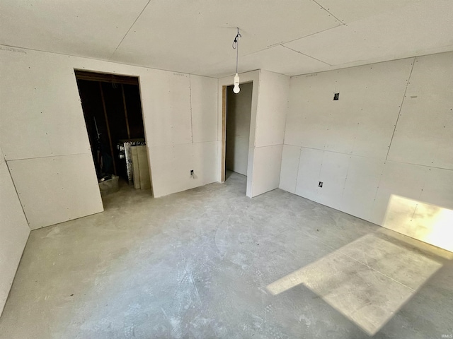 unfurnished bedroom featuring unfinished concrete flooring