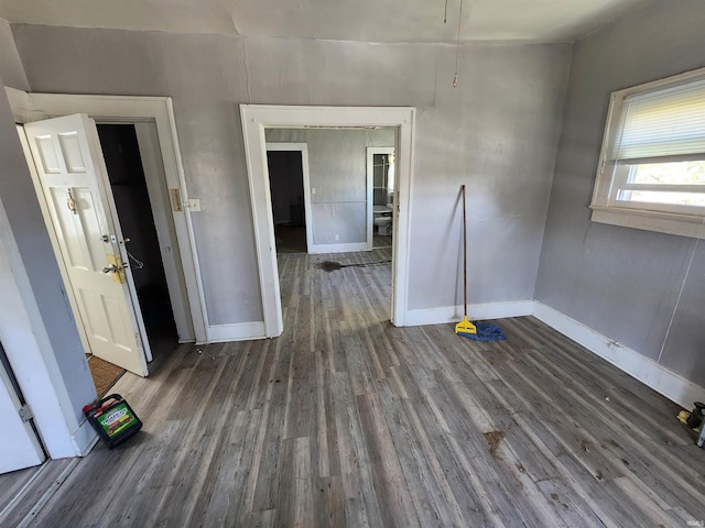 unfurnished room featuring wood finished floors and baseboards