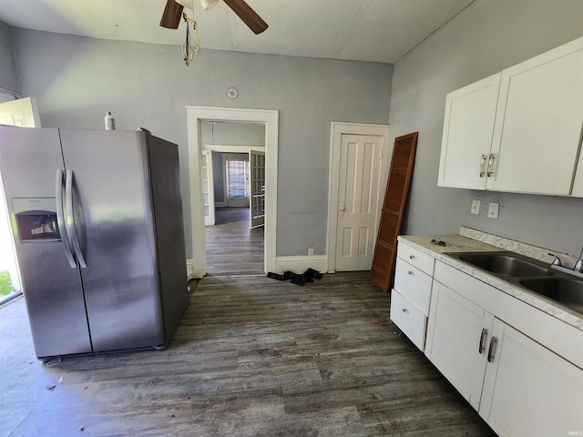kitchen with a ceiling fan, a sink, white cabinets, stainless steel refrigerator with ice dispenser, and dark wood-style flooring