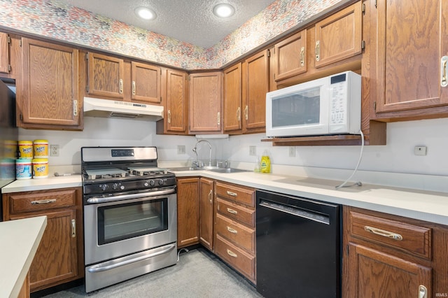 kitchen featuring stainless steel range with gas cooktop, white microwave, black dishwasher, light countertops, and under cabinet range hood