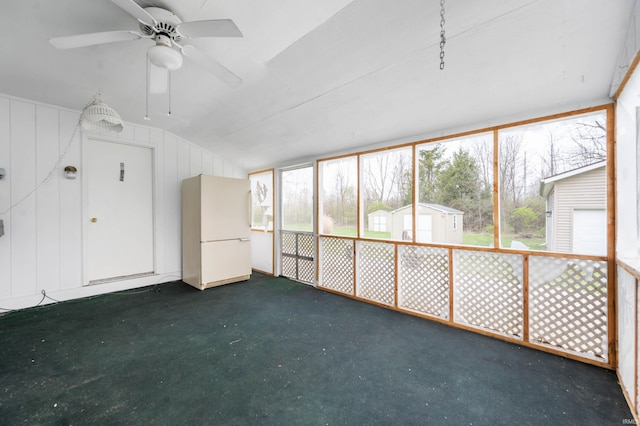 unfurnished sunroom with a ceiling fan