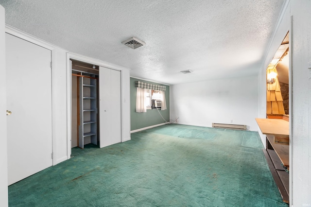 unfurnished bedroom with visible vents, cooling unit, a baseboard radiator, a textured ceiling, and carpet flooring