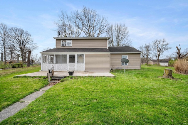 rear view of house featuring a sunroom, a yard, and a patio