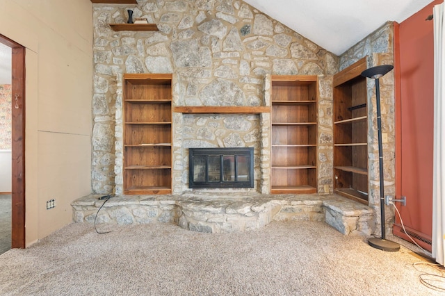 unfurnished living room with vaulted ceiling, carpet, and a fireplace
