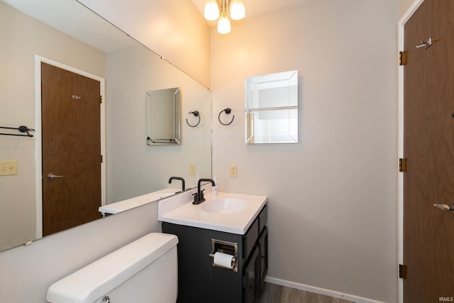 4829 Kintyre Dr, South Bend, IN 46614 - bathroom featuring baseboards, wood finished floors, vanity, and toilet