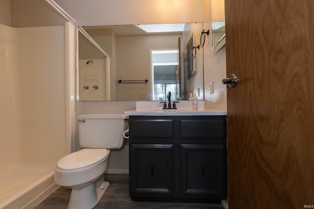 4829 Kintyre Dr, South Bend, IN 46614 - bathroom with toilet, a stall shower, baseboards, wood finished floors, and vanity