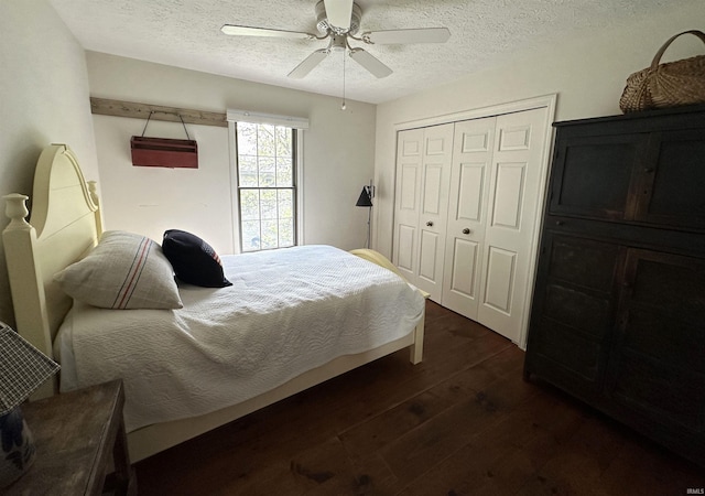 bedroom featuring a textured ceiling, a closet, ceiling fan, and dark wood finished floors