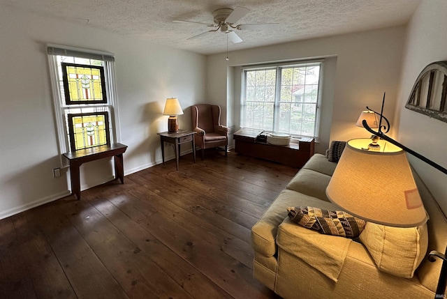 sitting room featuring wood-type flooring, a textured ceiling, baseboards, and ceiling fan