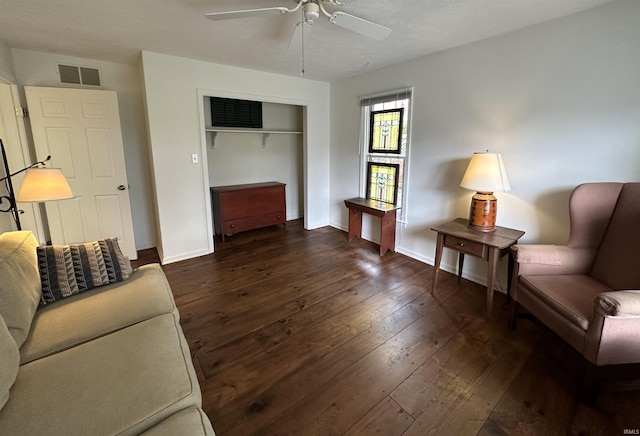 sitting room with dark wood-style floors, baseboards, ceiling fan, and visible vents