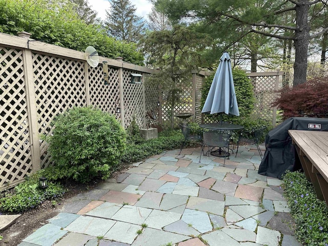 view of patio featuring outdoor dining area and fence