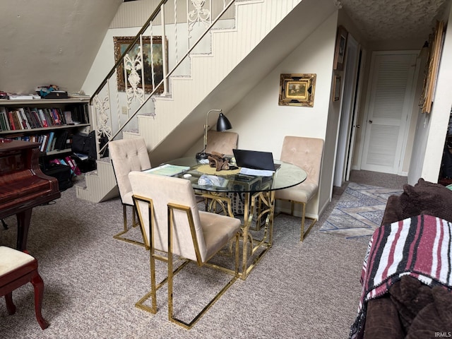 carpeted dining area featuring stairs