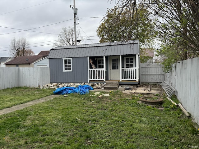 exterior space with a fenced backyard and covered porch