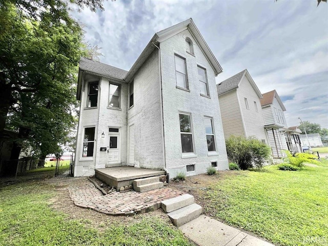 1926 W Indiana St, Evansville, IN 47712 - rear view of house featuring brick siding, a yard, and fence