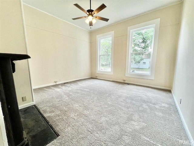 1926 W Indiana St, Evansville, IN 47712 - unfurnished living room featuring carpet, baseboards, and ceiling fan
