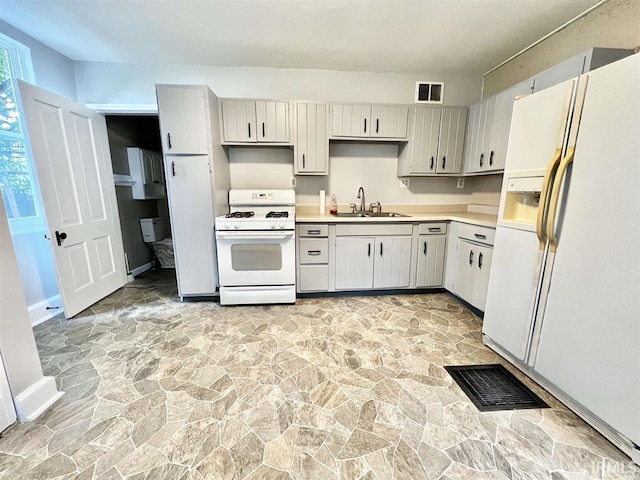 1926 W Indiana St, Evansville, IN 47712 - kitchen featuring visible vents, white appliances, and stone floors