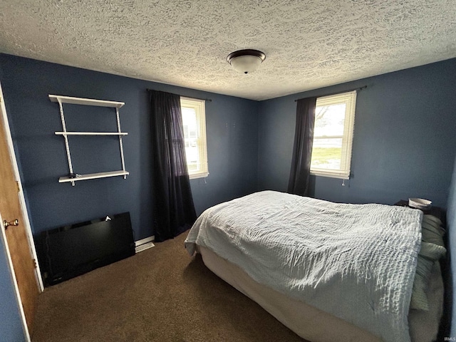 carpeted bedroom featuring baseboards and a textured ceiling