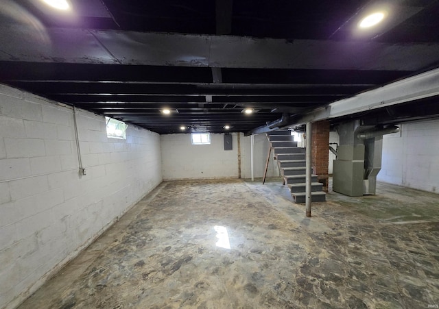 basement with stairs and heating unit