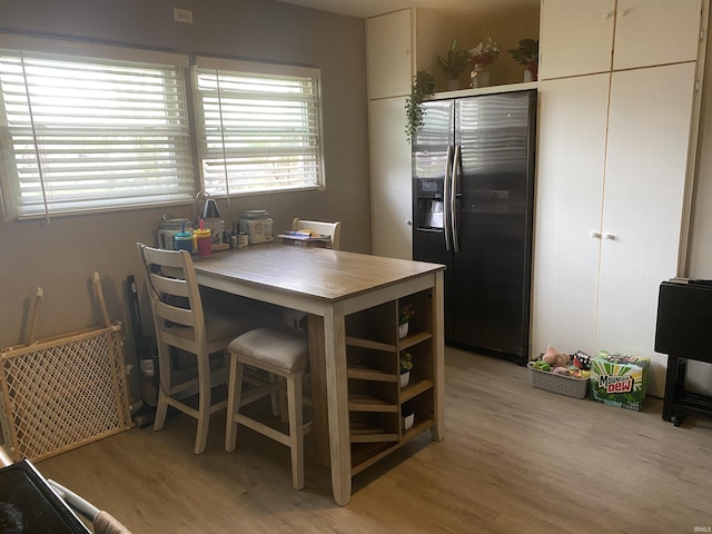 dining space featuring light wood finished floors
