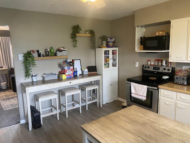 kitchen with open shelves, black microwave, electric stove, and dark wood-style floors
