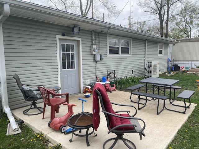 rear view of house with a patio area, a fire pit, and ac unit