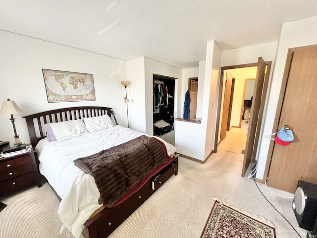 2421 S Brittany Ln, Bloomington, IN 47401 - bedroom featuring a closet, baseboards, and light carpet