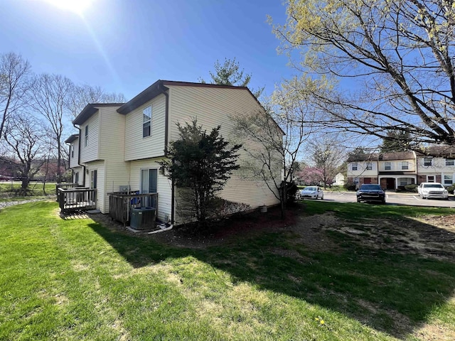 2421 S Brittany Ln, Bloomington, IN 47401 - view of side of home with a yard and central AC