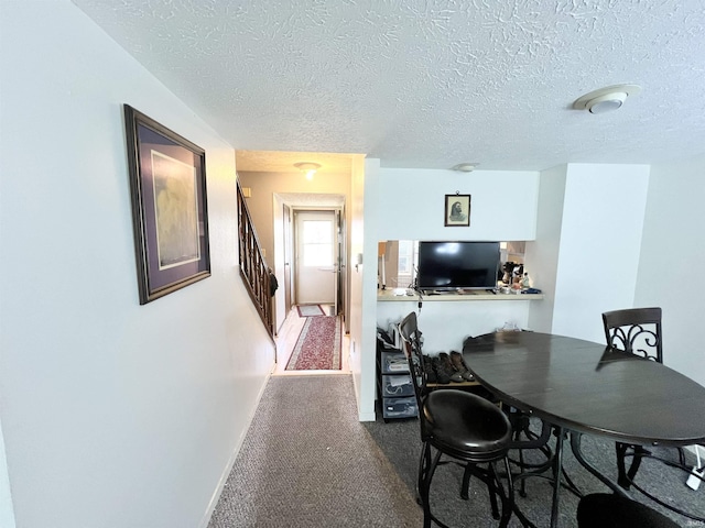 2421 S Brittany Ln, Bloomington, IN 47401 - dining space with dark carpet, a textured ceiling, and stairs