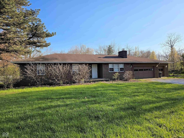 single story home with a front lawn, an attached garage, a chimney, and driveway