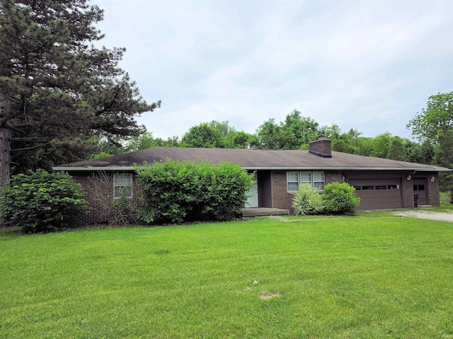 935 Fry Rd, Greenwood, IN 46142 - ranch-style home featuring an attached garage, a front lawn, brick siding, a chimney, and driveway
